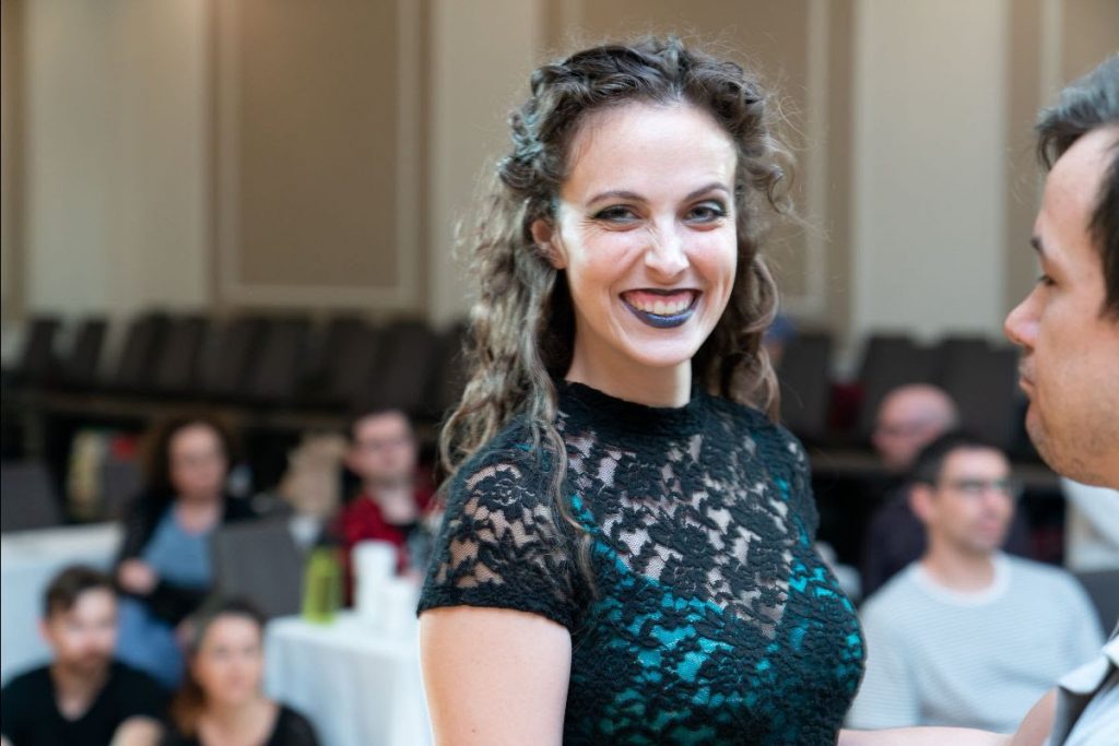 Photo of a woman with a black top and black lipstick